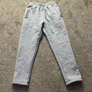 Fleece Lined sweat pants with a drawstring waistband and zip up pockets.